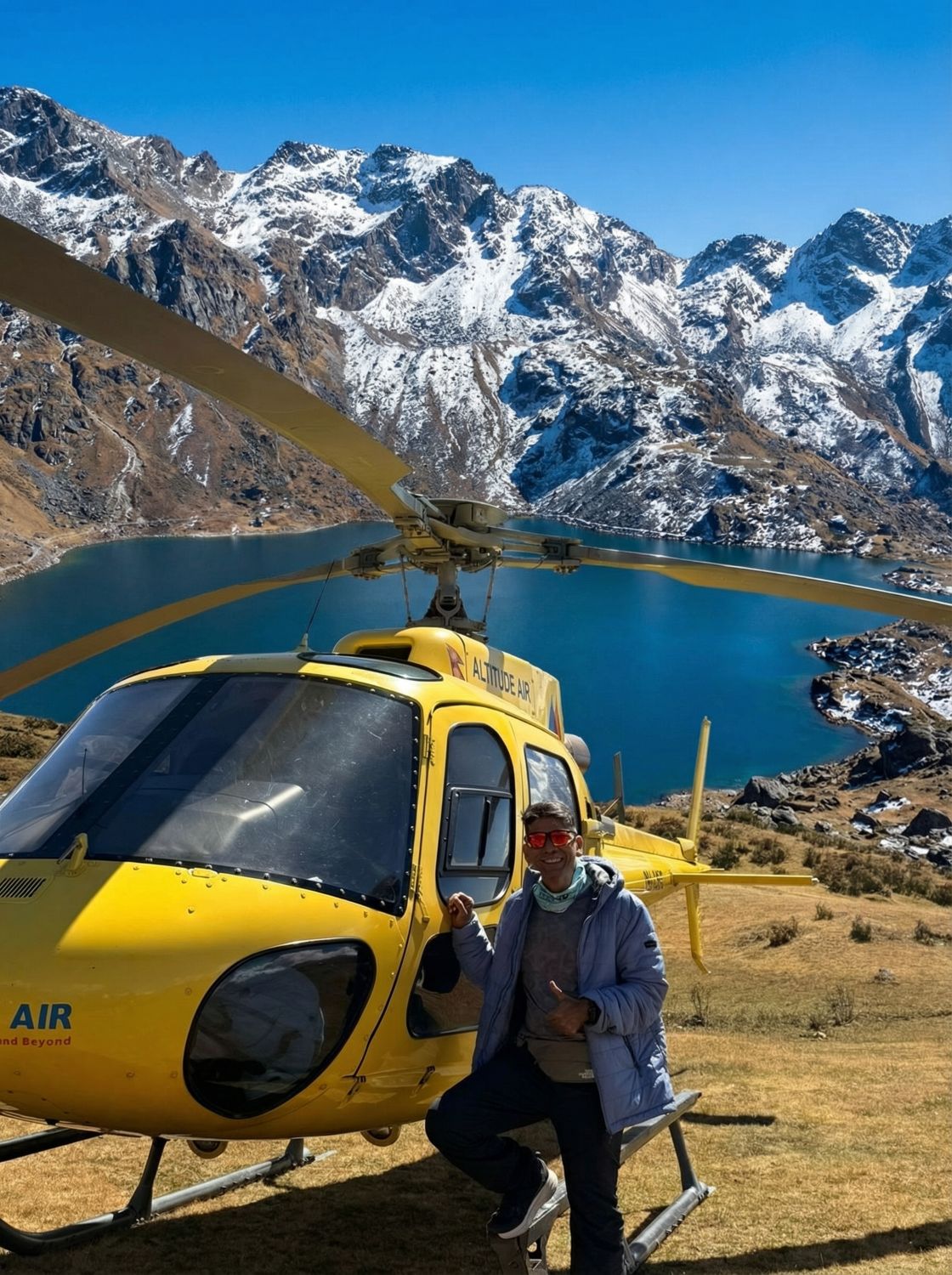 Tourists posing at Gosaikunda Lake after landing on a helicopter tour operated by Everest Helicopter Service.