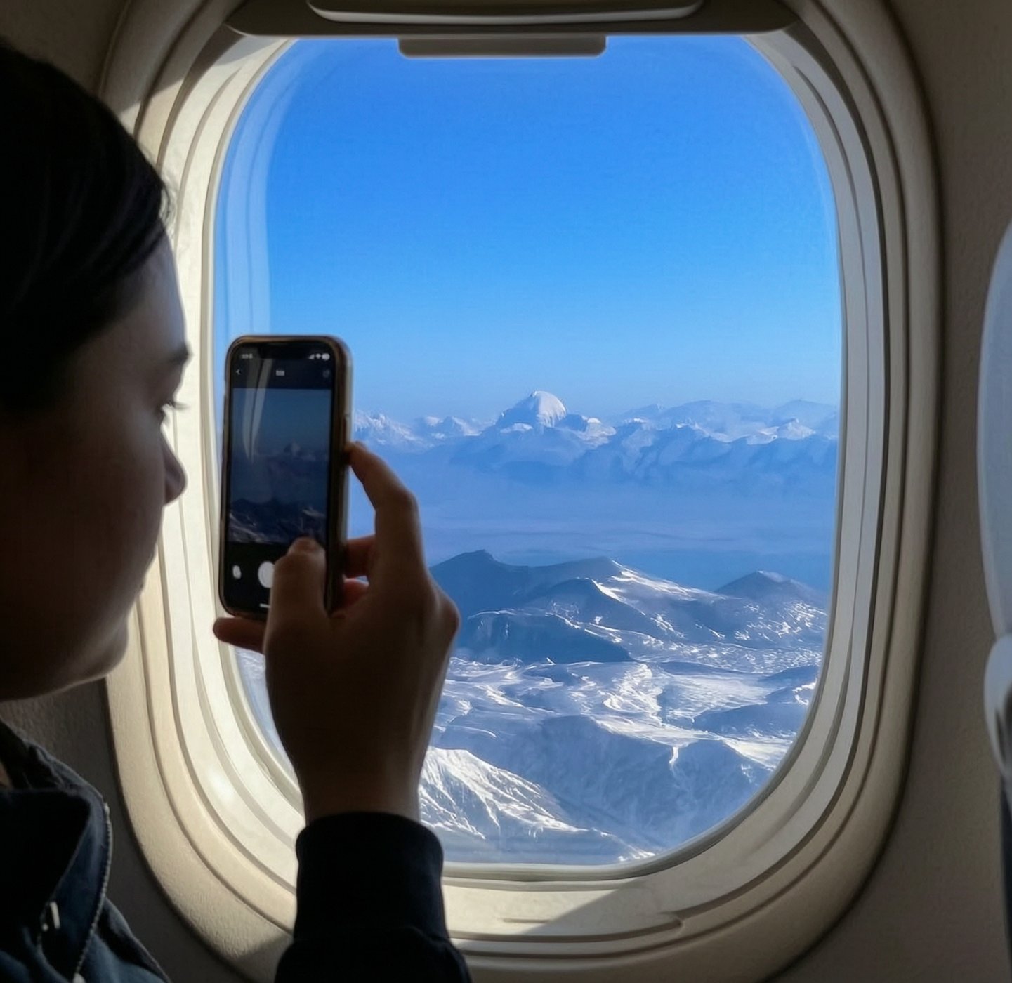 Guest taking video and picture of Kailash Mansarovar from plane during aerial flight