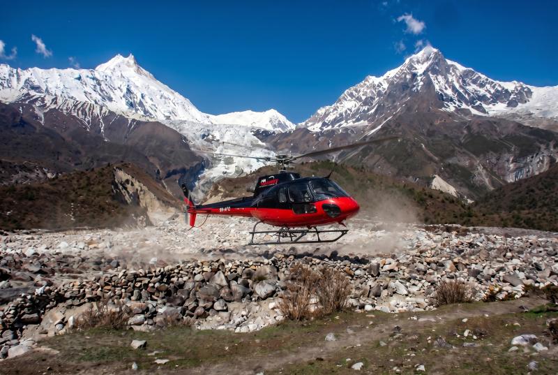 Helicopter landing to pick up guests during Manaslu Circuit Trek with Helicopter Return