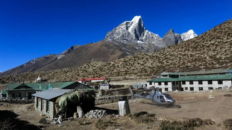 Helicopter landing to pick up guests during Dingboche to Lukla Helicopter Transfer